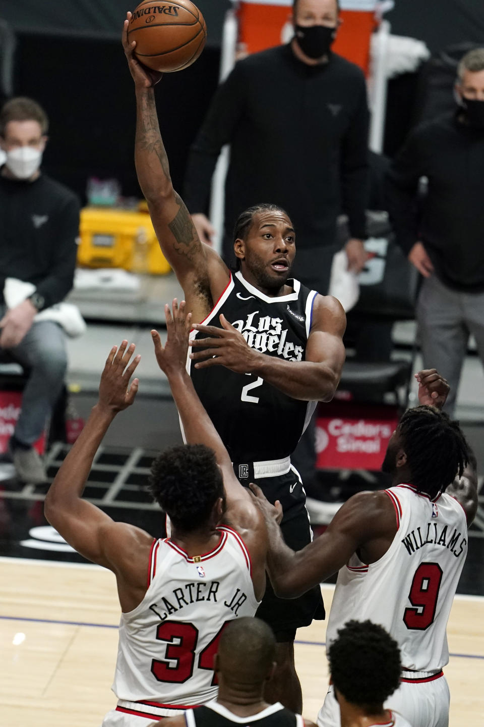 Los Angeles Clippers forward Kawhi Leonard, top, shoots against the Chicago Bulls during the first half of an NBA basketball game Sunday, Jan. 10, 2021, in Los Angeles. (AP Photo/Marcio Jose Sanchez)