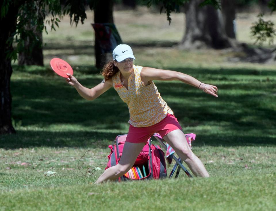 A disc golfer throws from the 6th fairway during the OTB Open Disc Golf Pro Tour at the Swenson Golf Course in Stockton. 