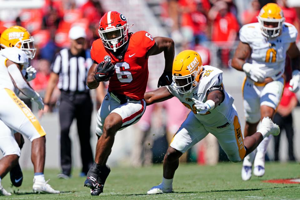 Georgia running back Kenny McIntosh tries to escape from Kent State linebacker Khalib Johns in the first half of last Saturday's game in Athens, Ga.