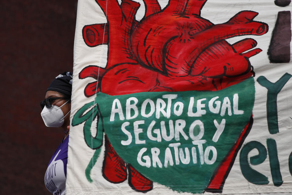 FILE - A woman holds a banner reading in Spanish, "Legal, safe, and free abortion" as abortion rights protesters demonstrate in front of the National Congress on the "Day for Decriminalization of Abortion in Latin America and the Caribbean," in Mexico City, Sept. 28, 2020. Mexico’s Supreme Court ruled in 2023 that national laws prohibiting abortions are unconstitutional and violate women’s rights. (AP Photo/Rebecca Blackwell, File)