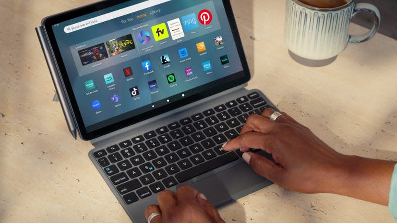 A user typing on the Amazon Fire Max 11 tablet's keyboard case.