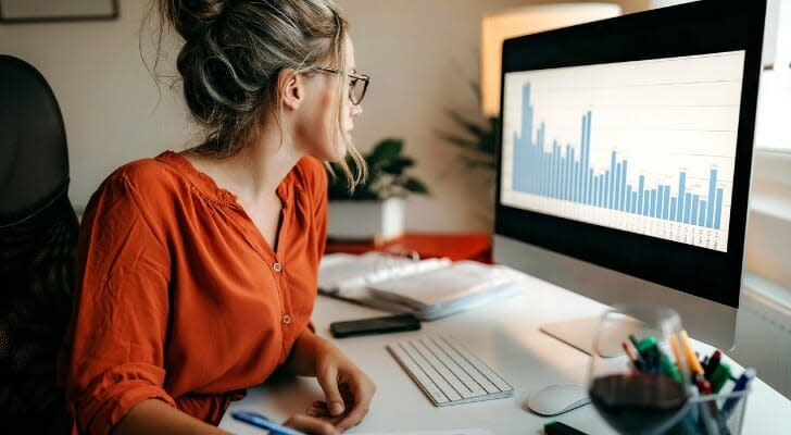 A trader sits in front of their computer and analyzes stock information from some after-hours trades.