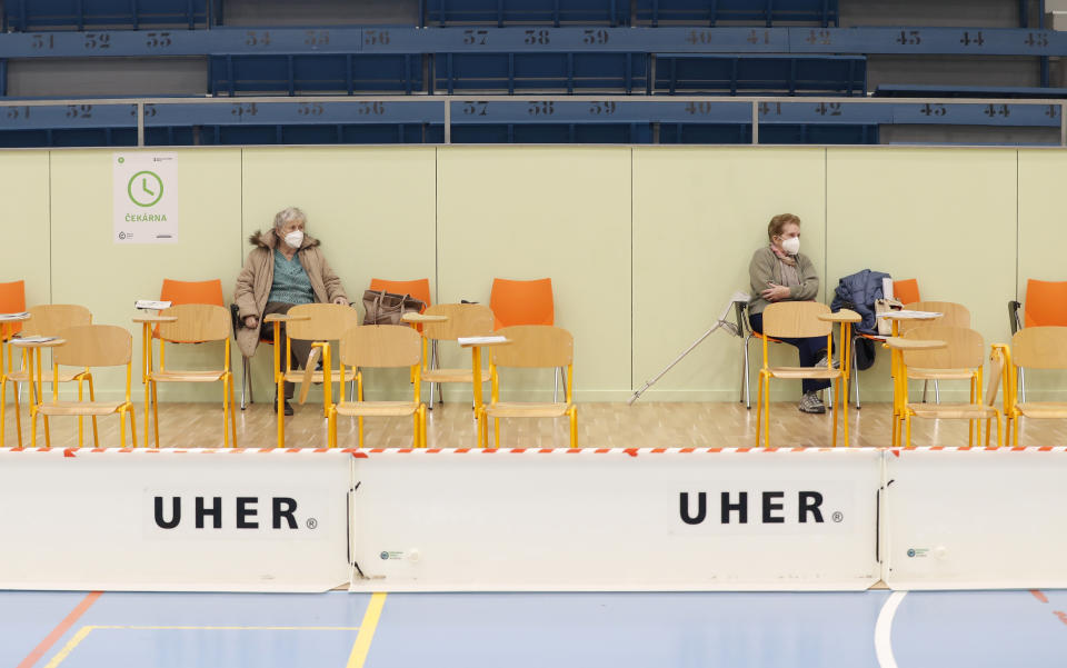 Elderly residents sit and wait after receiving Moderna COVID-19 vaccine at a sports hall in Ricany, Czech Republic, Friday, Feb. 26, 2021. With new infections soaring due to a highly contagious coronavirus variant and hospitals filling up, one of the hardest-hit countries in the European Union is facing inevitable: a tighter lockdown. (AP Photo/Petr David Josek)