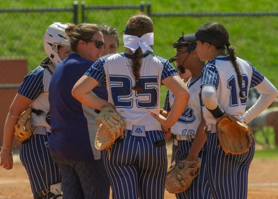 Spanish River High School Head Coach Ashley Byrd has a conference at the mound during the fourth inning against Plant High School during their FHSAA State 7A Championship softball game at the Legends Way Ball Fields in Clermont Saturday. May 27, 2023.