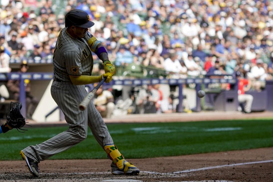 San Diego Padres' Manny Machado hits a double during the sixth inning of a baseball game against the Milwaukee Brewers Sunday, Aug. 27, 2023, in Milwaukee. (AP Photo/Morry Gash)