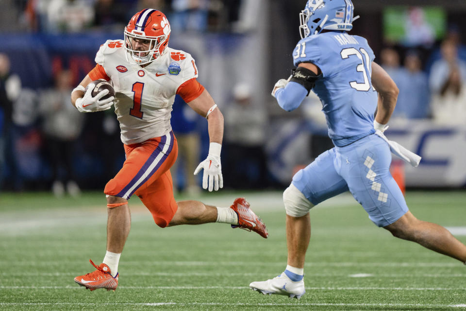 Clemson running back Will Shipley (1) carries while pursued by North Carolina defensive back Will Hardy (31) during the first half of the the Atlantic Coast Conference championship NCAA college football game Saturday, Dec. 3, 2022, in Charlotte, N.C. (AP Photo/Jacob Kupferman)