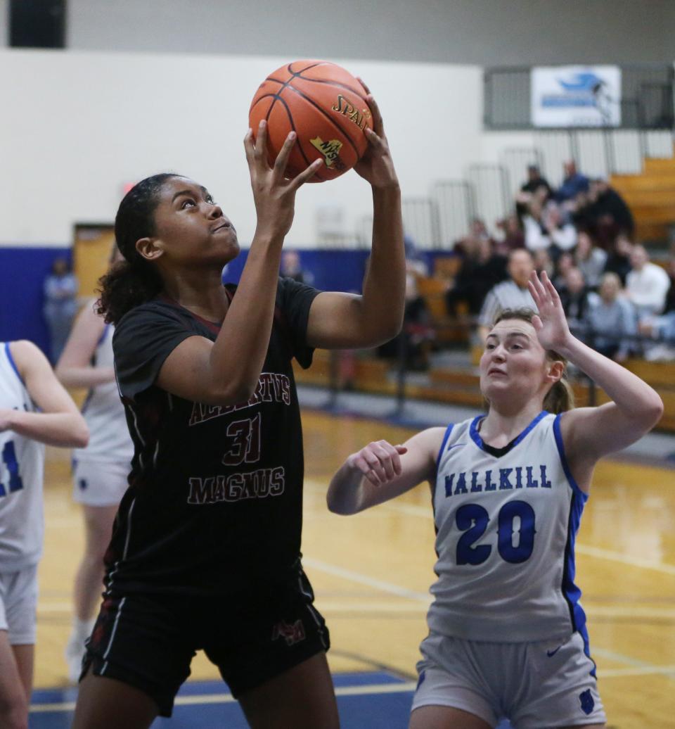 Albertus Magnus' Mikaiya Beasley secures a rebound over Wallkill's Emma Dilemme during a New York State Class AA regional girls basketball final on March 8, 2024.