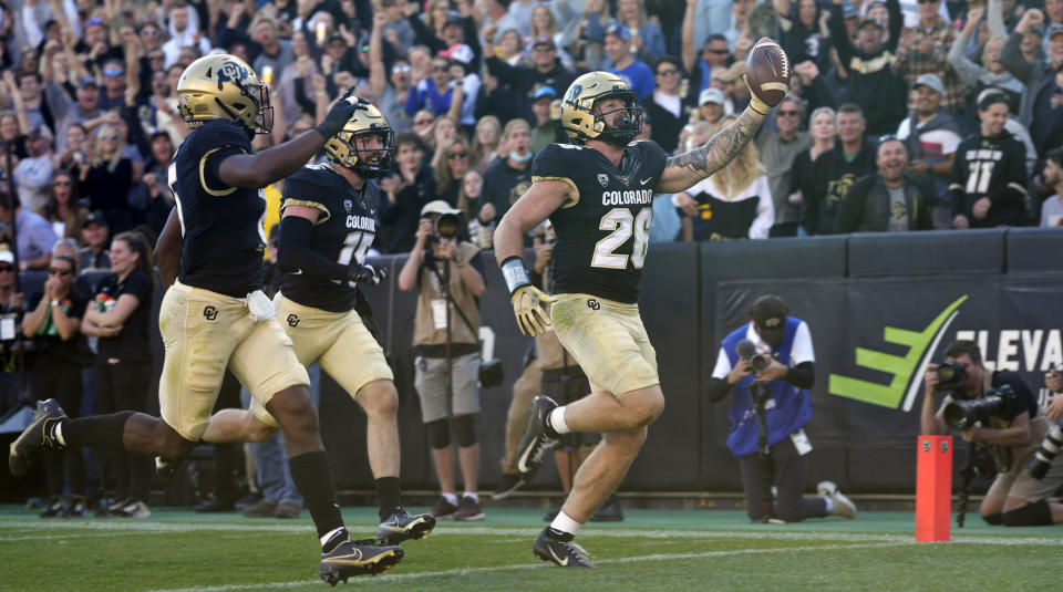 Colorado linebacker Carson Wells celebrates as he crosses into the end zone to score a touchdown on a pass interception against Arizona in the second half of an NCAA college football game Saturday, Oct. 16, 2021, in Boulder, Colo. (AP Photo/David Zalubowski)