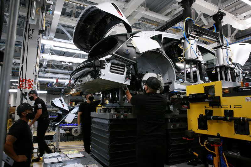 FILE PHOTO: Workers assemble electric vehicles at the Lucid Motors plant in Casa Grande