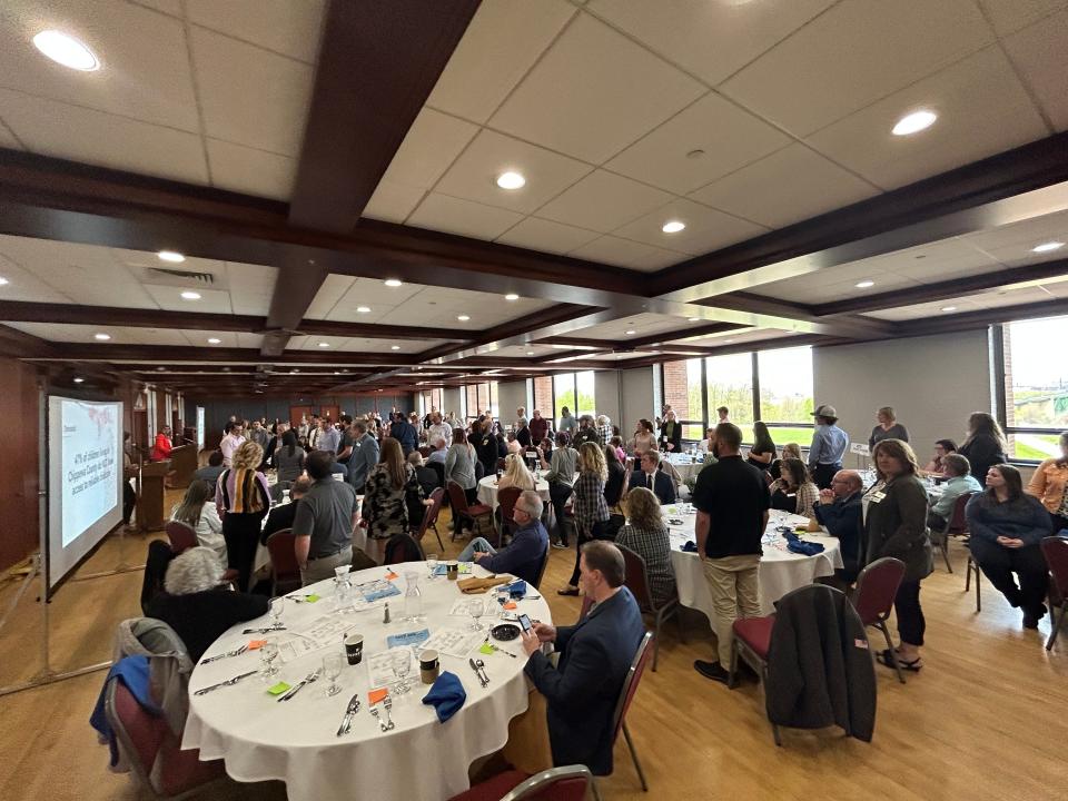 Sault residents in attendance at the annual spring economic luncheon participate in a display, the number of people standing represent all of the families in Chippewa County that don't have any access to child care.