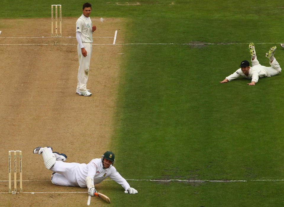 Graeme Smith of South Africa makes his ground after a throw from Kane Williamson of New Zealand (R) as Trent Boult looks on (C) during day one of the first Test between New Zealand and South Africa at the University Oval on March 7, 2012 in Dunedin, New Zealand.