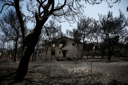 FILE PHOTO: A burnt house is seen following a wildfire in the village of Mati, near Athens, Greece, July 28, 2018. REUTERS/Costas Baltas