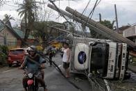 Residents are seen after Typhoon Kammuri hit Camalig town