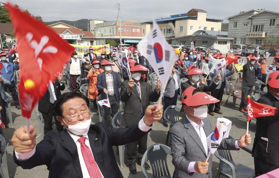 Local residents attend a rally calling for a pardon of Samsung Electronics' Vice Chairman Lee Jae-yong in Uiryeong, South Korea, on May 12, 2021. Pressure is mounting on South Korean President Moon Jae-in to pardon Samsung heir Lee Jae-yong, who is back in prison after his conviction in a massive corruption scandal, even though business has rarely looked better at South Korea’s largest company. (Kim Dong-min/Yonhap via AP)