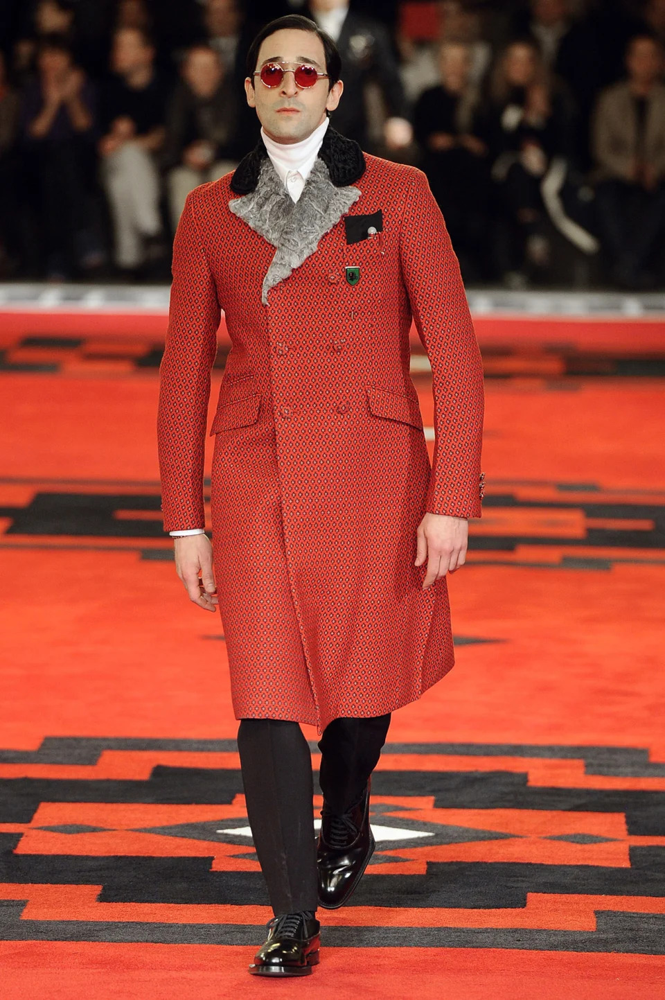 prada villains fashion show runway, MILAN, ITALY - JANUARY 15:  Actor Adrien Brody walks the runway at the Prada Autumn Winter 2012 fashion show during Milan Menswear Fashion Week on January 15, 2012 in Milan, Italy.  (Photo by Chris Moore/Catwalking/Getty Images)