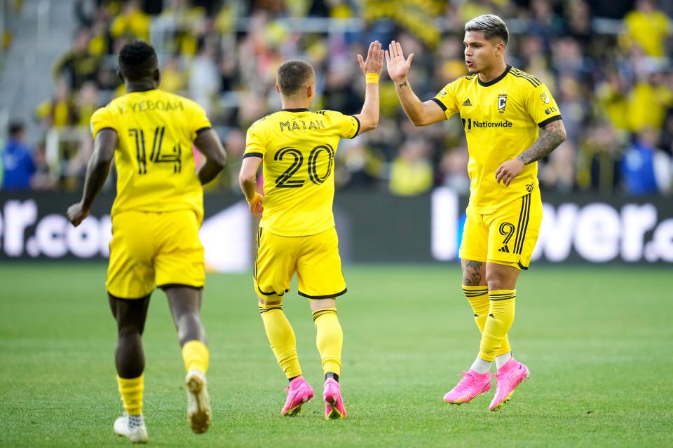 Apr 29, 2023; Columbus, Ohio, United States;  Columbus Crew forward Cucho Hernandez (9) high-fives midfielder Alexandru Matan (20) after scoring a goal during the first half of the MLS soccer game between Columbus Crew and Inter Miami at Lower.com Field on Saturday night. Mandatory Credit: Joseph Scheller-The Columbus Dispatch