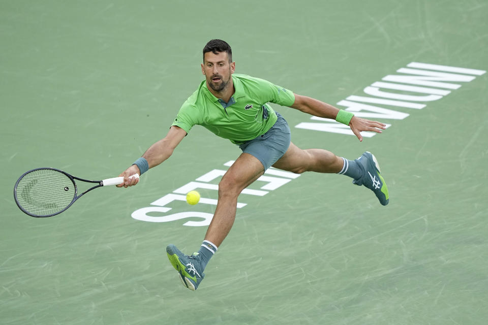 Novak Djokovic, of Serbia, returns a shot against Luca Nardi, of Italy, at the BNP Paribas Open tennis tournament, Monday, March 11, 2024, in Indian Wells, Calif. (AP Photo/Mark J. Terrill)