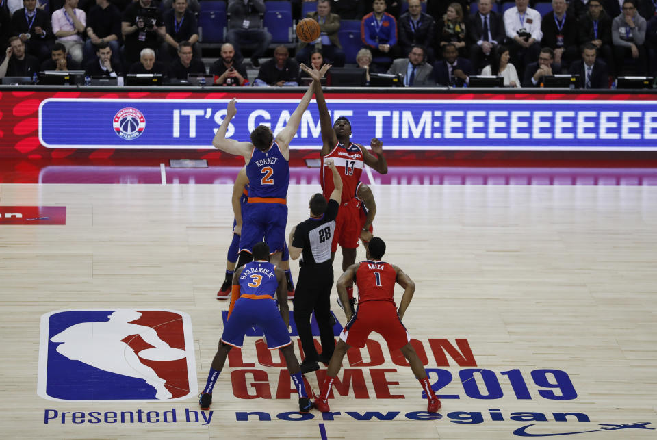 Washington Wizards center Thomas Bryant (13), left, challenges for the ball with New York Knicks forward Luke Kornet (2) during an NBA basketball game between New York Knicks and Washington Wizards at the O2 Arena, in London, Thursday, Jan.17, 2019. (AP Photo/Alastair Grant)