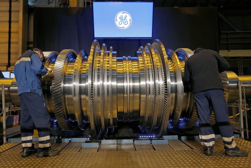 FILE PHOTO: Employees work on a turbine at the General Electric plant in Belfort