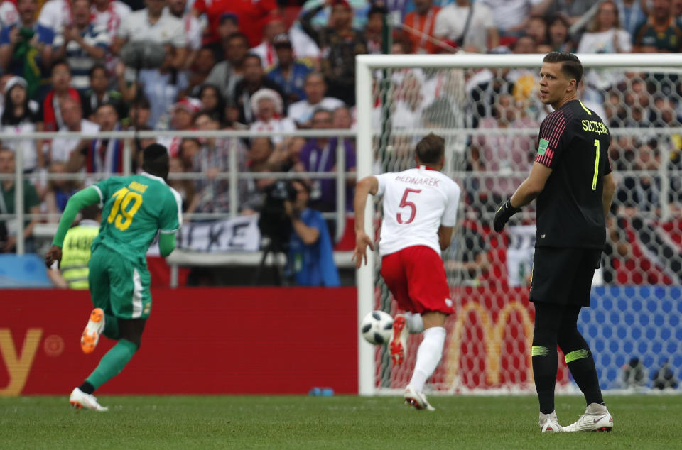 <p>Poland goalkeeper Wojciech Szczesny looks back as Mbaye Niang has a free 35-yard run on goal to put Sengegal 2-0 up </p>