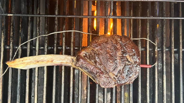 cooked tomahawk steak on grill