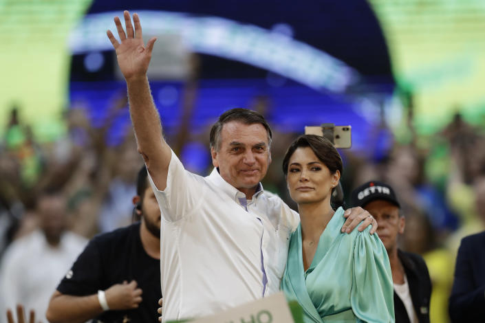 Brazil's President Jair Bolsonaro and his wife Michelle Bolsonaro greet the crowd during a rally to launch his reelection bid, in Rio de Janeiro, Brazil, Sunday, July 24, 2022. Brazil's general elections are scheduled for Oct. 2, 2022. (AP Photo/Bruna Prado)
