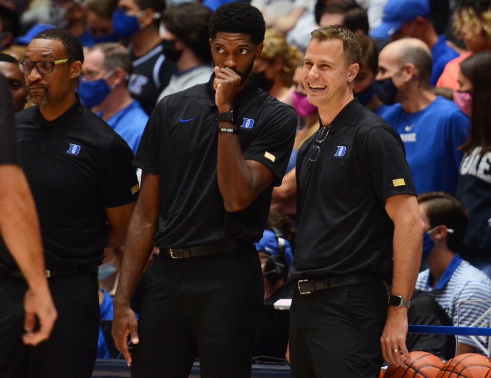 Oct 15, 2021; Durham, NC, USA;  Duke Blue Devils associate head coach Jon Scheyer (right) has a laugh during Duke Countdown to Craziness at Cameron Indoor Stadium.