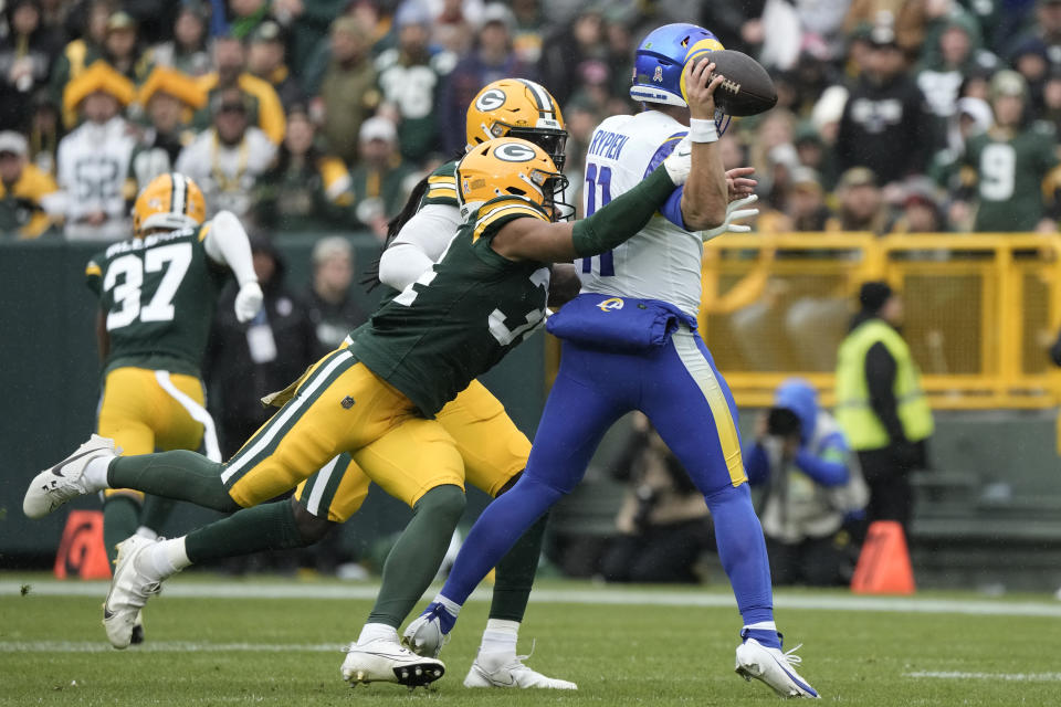 Los Angeles Rams quarterback Brett Rypien (11) fumbles the football while hit by Green Bay Packers cornerback Jaire Alexander (23), front left, during the first half of an NFL football game Sunday, Nov. 5, 2023, in Green Bay, Wis. (AP Photo/Morry Gash)