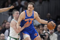 New York Knicks forward Bojan Bogdanovic (44) drives against Boston Celtics guard Payton Pritchard (11) during the first half of an NBA basketball game Thursday, April 11, 2024, in Boston. (AP Photo/Steven Senne)