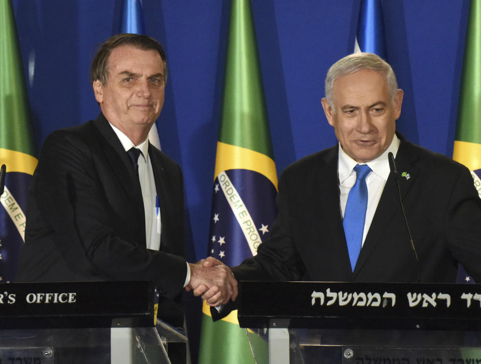 Brazilian President Jair Bolsonaro and Israel Prime Minister Benjamin Netanyahu, right, shake hands during a joint media conference at the prime minister's residence in Jerusalem, Sunday March 31, 2019. Bolsonaro is in Israel on a four day official visit. (Debbie Hill/Pool via AP)