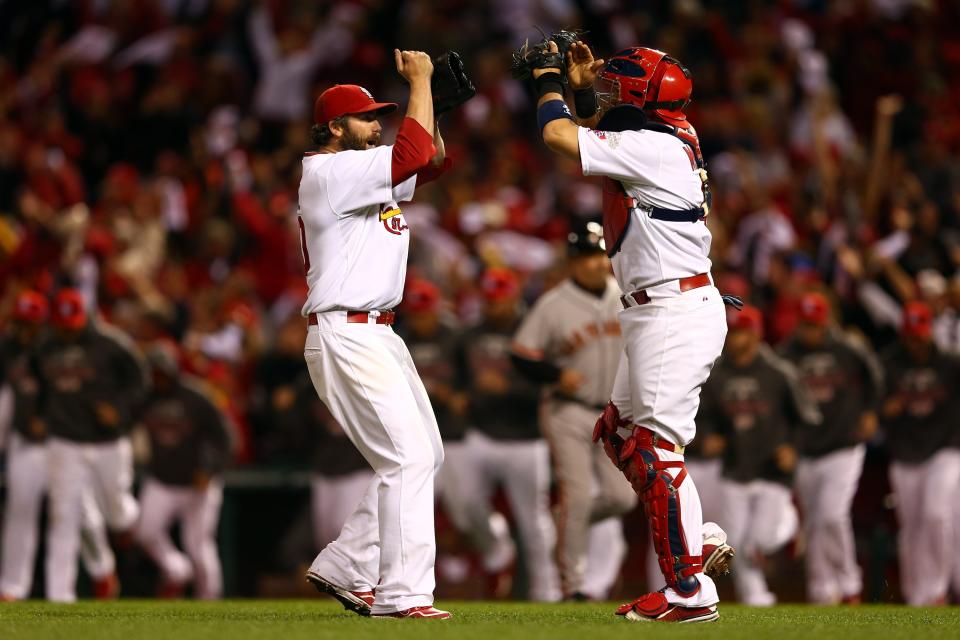 ST LOUIS, MO - OCTOBER 17: Jason Motte #30 and catcher Yadier Molina #4 of the St. Louis Cardinals celebrate the Cardinals 3-1 victory against the San Francisco Giants in Game Three of the National League Championship Series at Busch Stadium on October 17, 2012 in St Louis, Missouri. (Photo by Elsa/Getty Images)