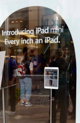 Customers shop at an Apple Store in Los Angeles on Thursday. Apple's late co-founder Steve Jobs had once derided the whole concept of small tablets, saying they should be packaged with sandpaper, "so that the user can sand down their fingers to around one quarter of the present size"