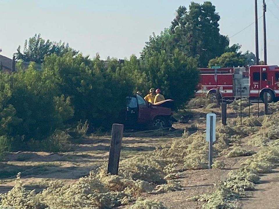 Investigators look at a car involved in a fatal crash Friday, Sept. 1, 2023, near Jefferson and Bethel avenues in Fresno County.