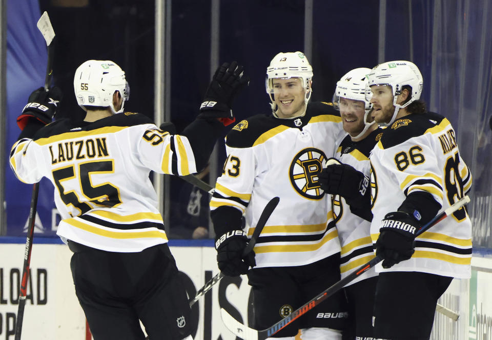 Boston Bruins' Chris Wagner (14), second from right, celebrates his short-handed goal against the New York Rangers with Jeremy Lauzon (55), Charlie Coyle (13) and Kevan Miller (86) during the second period of an NHL hockey game Wednesday, Feb. 10, 2021, in New York. (Bruce Bennett/Pool Photo via AP)