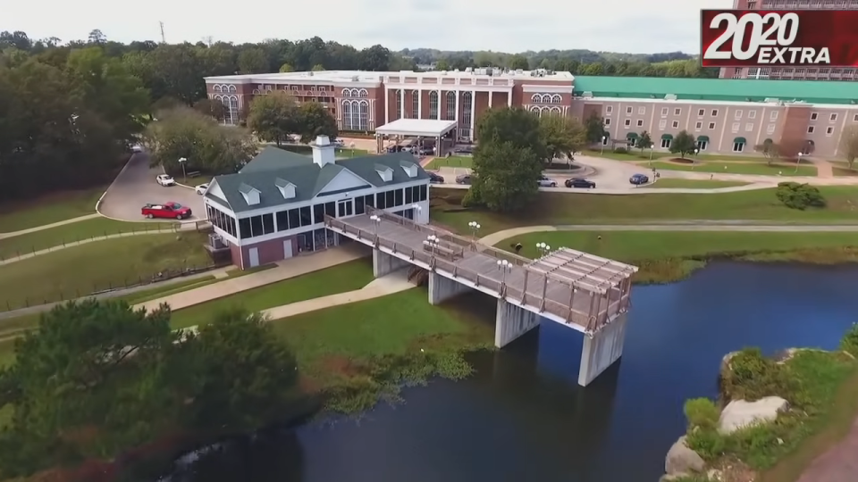 Aerial view of a building complex with a bridge over water, displaying "2020 EXTRA" text overlay