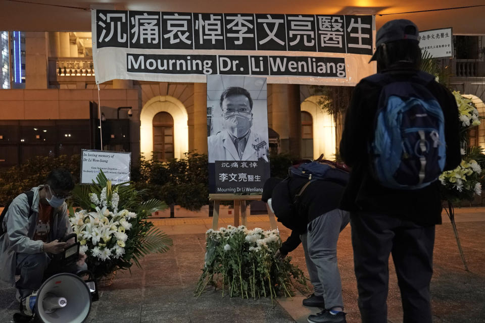 People attend a vigil for Chinese doctor Li Wenliang, in Hong Kong, Friday, Feb. 7, 2020. The death of a young doctor who was reprimanded for warning about China's new virus triggered an outpouring Friday of praise for him and fury that communist authorities put politics above public safety. (AP Photo/Kin Cheung)