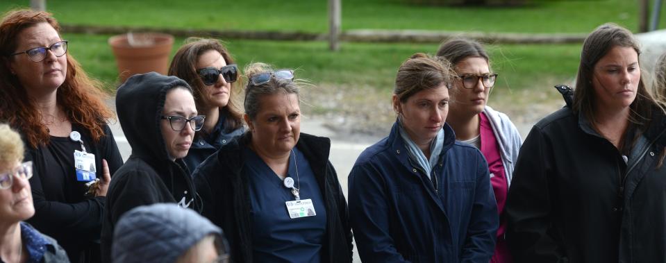 Hospital staff circle around the Global Pandemic stone during a brief ceremony ahead of walkers pushing the 5,000-pound memorial on April 14, 2022, Stonewalk from Cape Cod Hospital to the Hyannis Village Green as a remembrance to Covid victims. Steve Heaslip/Cape Cod Times