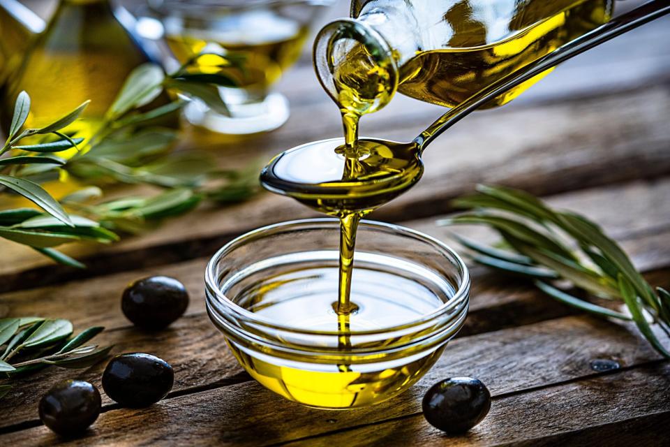 Olive Oil Pouring Into Dish