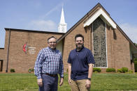 The Rev. Ed McKinney, pastor of Stokesdale United Methodist Church, left, and Michael Hahn, right, pose for a photo at the church in Stokesdale, N.C., Monday, May 15, 2023. Hahn and his family are among a group of newcomers who have begun participating in Stokesdale after their previous congregations left the denomination. (AP Photo/Chuck Burton)