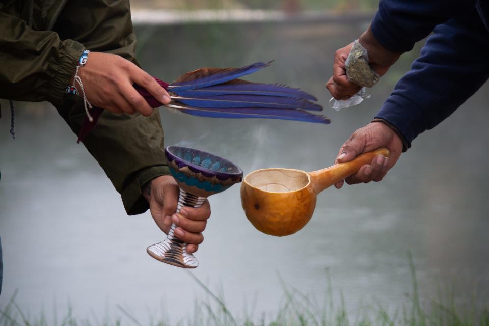 Before beginning each manifestation, the group performs a ceremony to honor water, the elements, and ancestors.