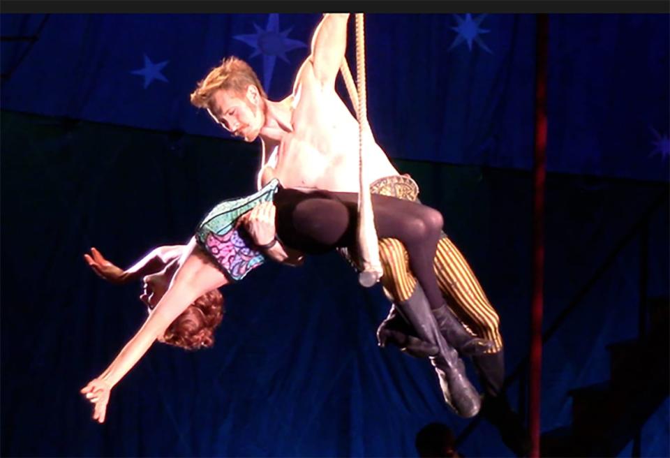 Annie Potts held by an acrobatic performer in a still from 'Pippin'