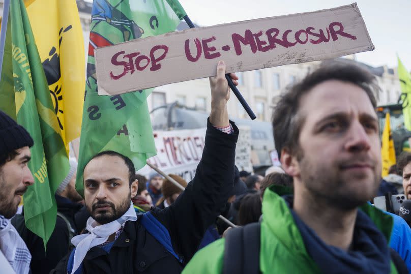 People gather outside the European Parliament during a protest by farmers as European leaders meet for an EU summit in Brussels, February 2024