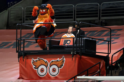Philadelphia Flyers mascot Gritty reacts from his perch to a Flyers goal during the first period of the team's NHL hockey game against the Pittsburgh Penguins, Wednesday, Jan. 13, 2021, in Philadelphia. (AP Photo/Chris Szagola)