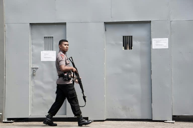 A policeman patrols on July 25, 2016 outside the only entrance to Indonesia's highest security Nusakambangan prison in Cilacap, home to a high-security prison where the country conducts executions