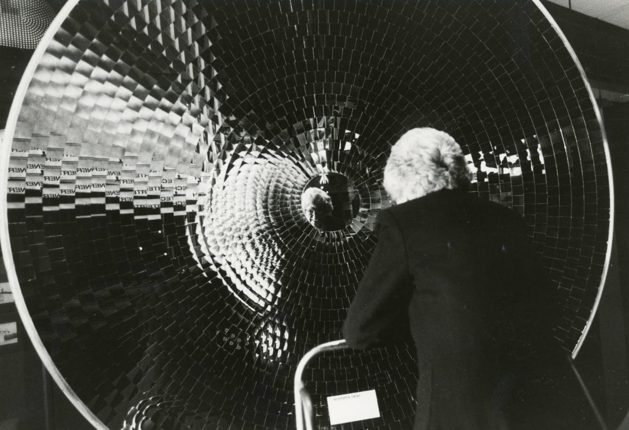 1983 - Mrs. Floradelle Pfahl, of Columbus, a COSI board member, talks to her husband John through the whisper dish, which amplifies sound.