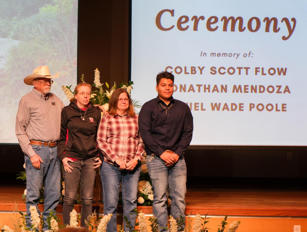 The family of Daniel Wade Poole stand with Efrain Rosales, a recipient of a scholarship in his memory Friday at a student memorial service at West Texas A&M in Canyon.
