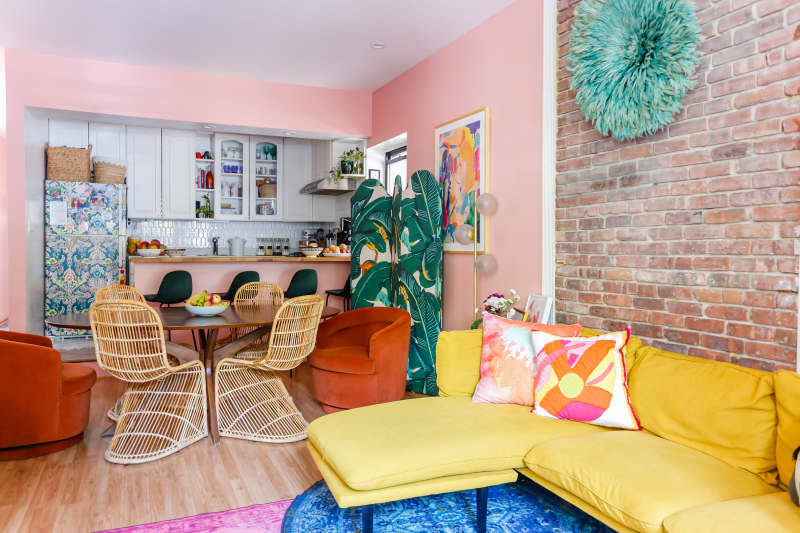 Pink kitchen with lots of color accents and art