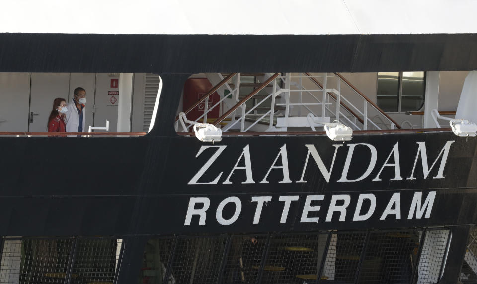 Two people look off the stern of the cruise ship Zaandam after it docked at Port Everglades during the new coronavirus pandemic, Thursday, April 2, 2020, in Fort Lauderdale, Fla. Those passengers that are fit for travel in accordance with guidelines from the U.S. Centers for Disease Control will be permitted to disembark. (AP Photo/Wilfredo Lee)