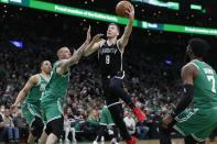 Brooklyn Nets' Goran Dragic (9) shoots against Boston Celtics' Daniel Theis, front left, during the first half of Game 2 of an NBA basketball first-round Eastern Conference playoff series Wednesday, April 20, 2022, in Boston. (AP Photo/Michael Dwyer)
