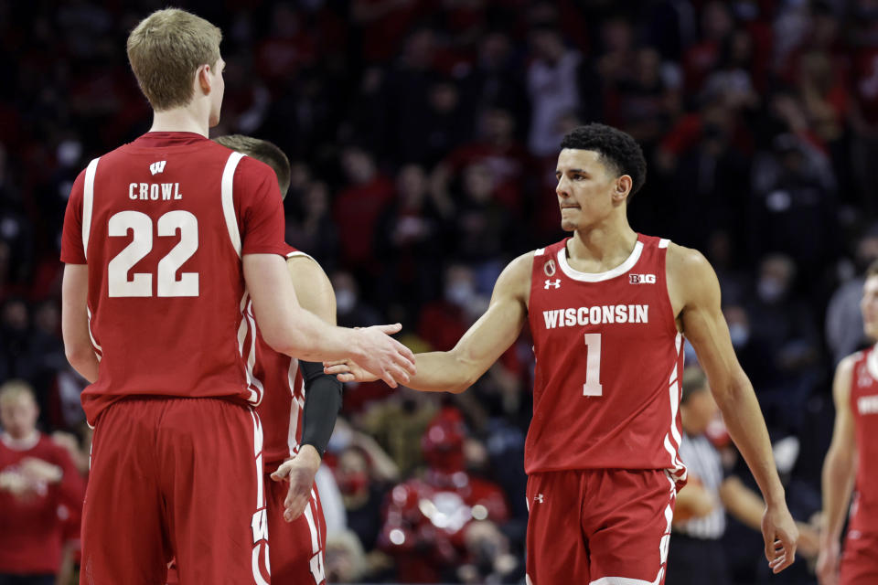 Wisconsin guard Johnny Davis (1) reacts with forward Steven Crowl during the second half of an NCAA college basketball game against Rutgers, Saturday, Feb. 26, 2022, in Piscataway, N.J. (AP Photo/Adam Hunger)